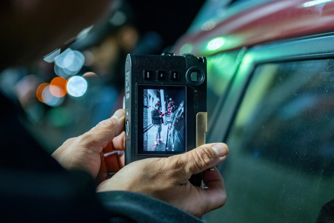 Video editors reviewing footage together on a monitor in a production studio